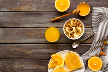 Vegetarian breakfast with granola and fruits on wooden background top-down frame copy space