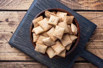 Cookies with chocolate filling, flakes from natural cereals. Healthy Breakfast with milk. Wooden table. Copy space
