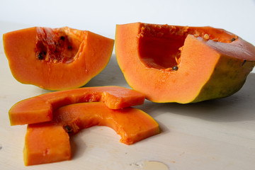 Sliced papaya on a white cutting board