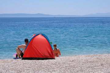 Tent for relax on sea resort. Summer vacations and travel for seaside. Seascape.