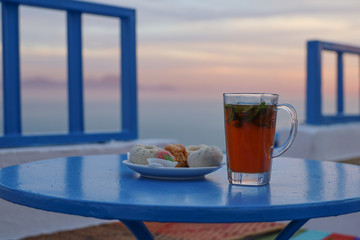 Tea and tunisian pastries on a table in Sidi Bou Said in Tunisia 