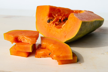 Sliced papaya on a white cutting board
