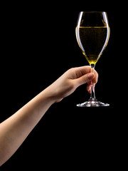 Woman hand holding white wine glass isolated on black.