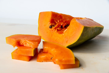 Sliced papaya on a white cutting board