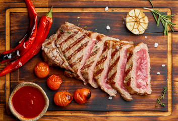 Paleo food recipe with grilled fried chopped piece of meat, papper, top view, close up