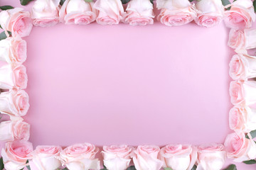 frame border  of pink roses around the edges on a pink background