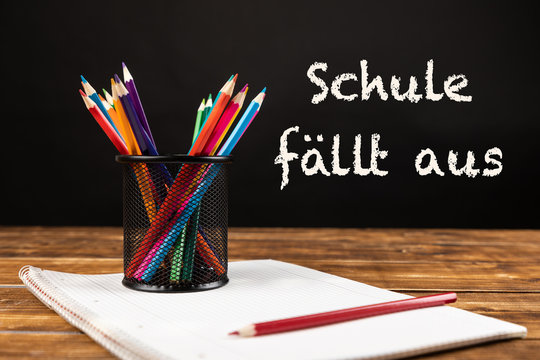 Colored Pencils With Paper And German Text Schule Fällt Aus, In English School Is Canceled