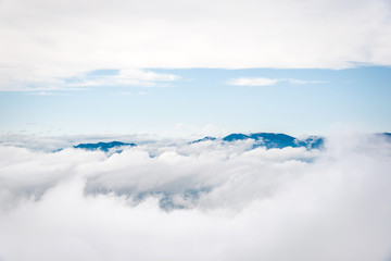 Mountain peaks covered in fog and clouds