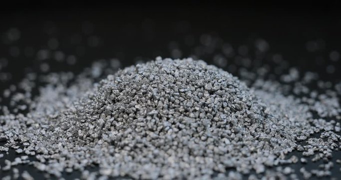 Silver mining, sprinkle fraction of rare metal on black background