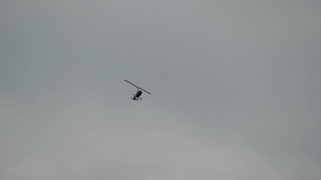 Gyroplane flying in the sky over the airfield. Aviation festival holiday at the aerodrome airport