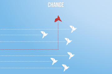 Think differently concept. Be different. Red bird changing direction. New idea, change, trend, courage, creative solution, innovation and unique way concept
