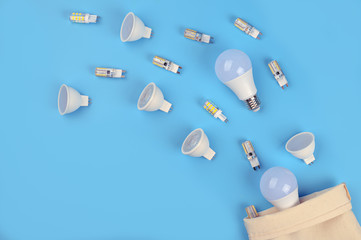 Several LED bulb on blue background. Saving energy concept. Ftat lay, top view, copy space. Bulbs...