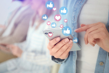Young woman using modern smartphone indoors, closeup