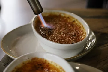 Fotobehang Preparation of a crème brûlée in a restaurant © M.Etcheverry