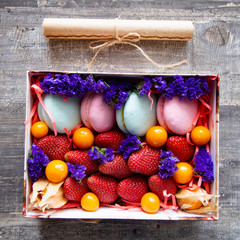 gift box with berries and macaroons