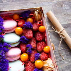 gift box with berries and macaroons