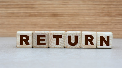 concept of the word return on cubes on a wooden background