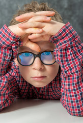 portrait of pensive cute child with checkered shirt