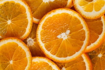 juicy oranges cut round on a dark background close up