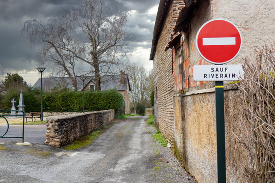 No entry road sign in small french village, except residents (sauf riverain )