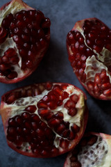 pomegranate berries are red close-up on a dark blue background. cut garnet with blurred background