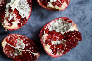 pomegranate berries are red close-up on a dark blue background. cut garnet with blurred background