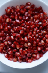 pomegranate berries are red close-up on a dark blue background. cut garnet with blurred background