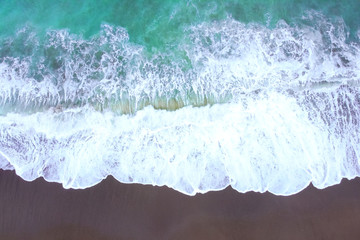 Beach top view from drone or aerial view with shade emerald blue water and wave foam