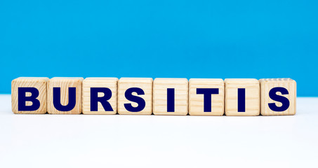 concept word bursitis on cubes on a blue background