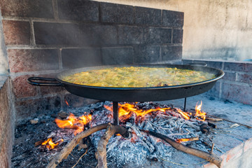 Preparing typical spanish paella on firewood closeup