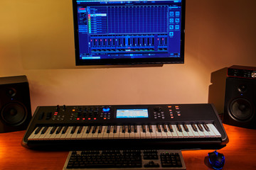 Home studio composed of synthesizer, monitors, computer and audio interface