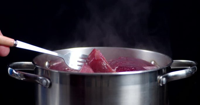 Fresh beets are boiled in the pot.