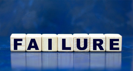 Fototapeta premium concept word failure on cubes on a blue background