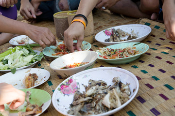 eating noreasthern food menu with hand on rattan mat