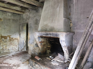 Old fireplace inside an abandoned house in the swamp