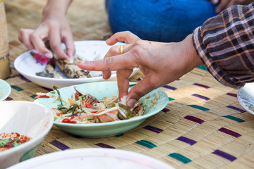 eating noreasthern food menu with hand on rattan mat