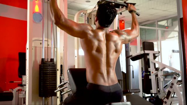 Man working out lat pulldown training at gym Upper body strength exercise for the upper back. Fit male doing cross training at gym