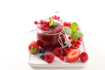 berry fruit jam, confiture with blueberry, raspberry and strawberry isolated on white background