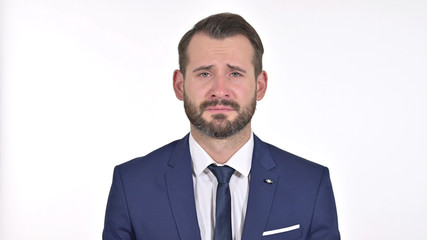 Portrait of Upset Young Businessman Crying at the Camera, White Background