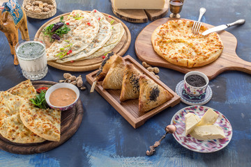 khachapui, dolma, cheburek and samsa assorted asian food appetizer on blue background
