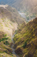 Santo Antao, Cape Verde. Canyon with steep cliff and winding riverbed with lush green vegetation on Delgadinho mountain ridge