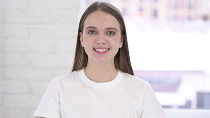 Portrait of Beautiful Young Woman Looking at Camera and Smiling