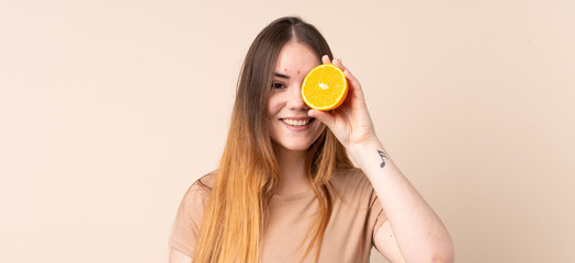 Young caucasian woman holding an orange