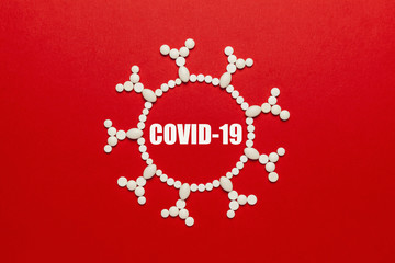 Virus concept made of pills on red background. Epidemic of coronavirus (COVID-19), dangerous...