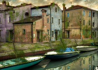 Fototapeta na wymiar Abandoned buildings covered with grass and rust in Venice Italy.