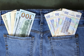 Banknotes of different denominations in the pocket of women's jeans, background. Concept, American...