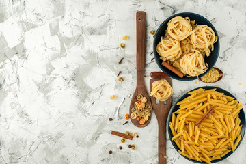different paste in blue ceramic dishes on a textured white-gray concrete background