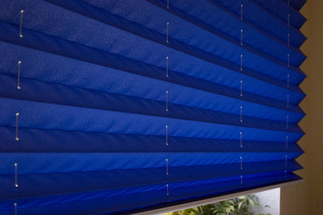 Pleated blinds XL Coulisse, blue color, with 50mm fold closeup in the details on the window in the...