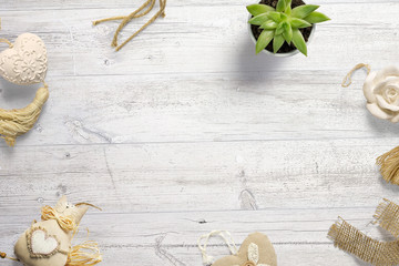 Decorative childhood objects on painted wooden desks composition with free space in the centre for text, logo, message as template for hero header images. Flat lay. Top vie