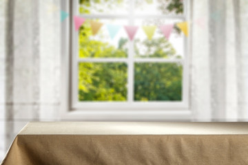 Desk of free space for your decoration and blurred window sith spring decoration. 